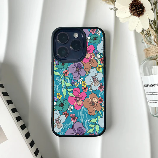 Phone case covered in a dense, colorful hand-drawn floral pattern on a bright teal background.